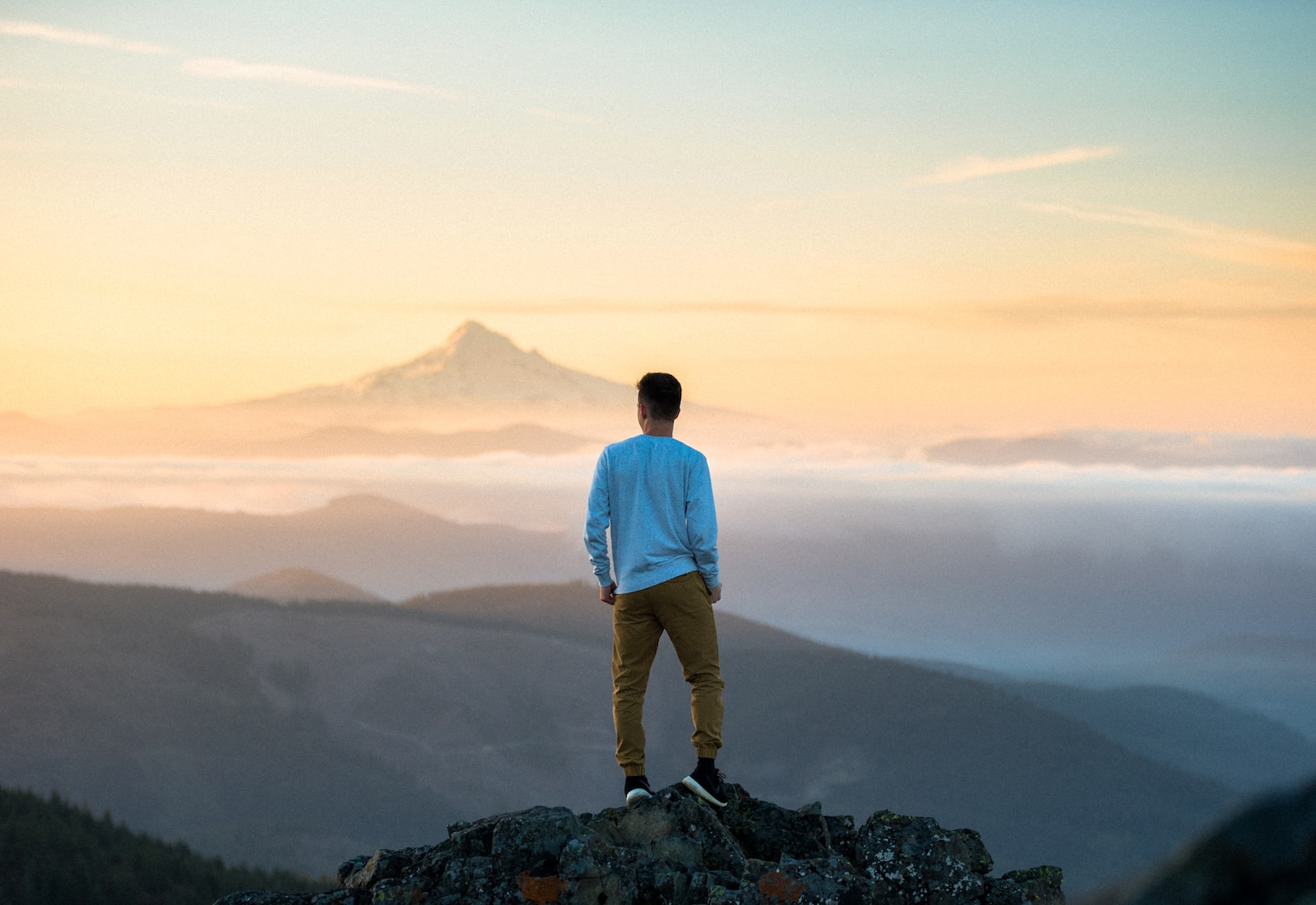 Photo by Tim Bogdanov man standing on top of mountain